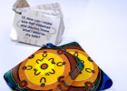 An array of cards with colourful design on the front and text on the back.