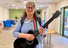 Winnifred Beevers music therapist with guitar